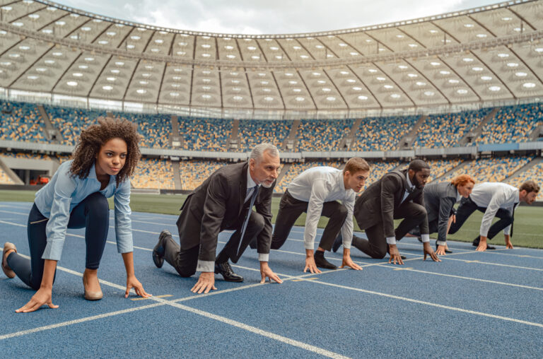 Business leaders lined up at a starting line, representing a Total Rewards strategy shifting from cost center to competitive advantage