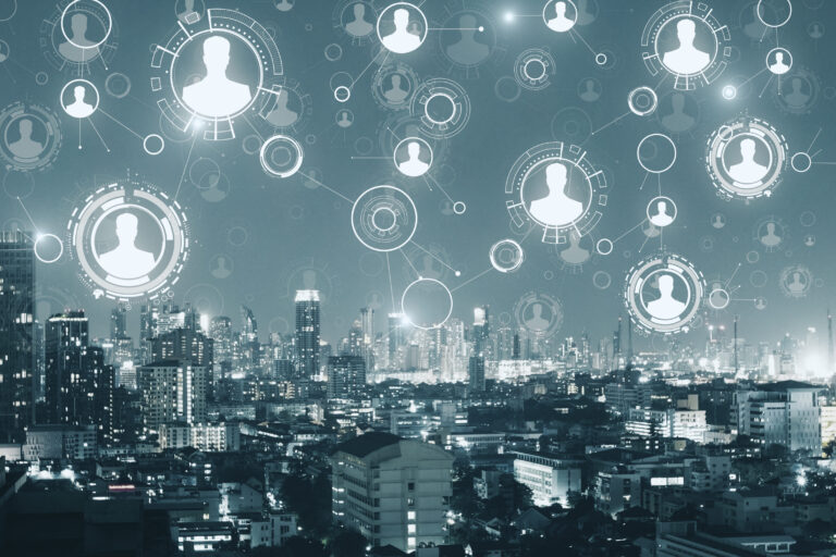 Abstract city skyline at night overlaid with connected digital profile icons and data nodes, representing interconnected HR data, workforce analytics, and the challenge of turning complex people data into actionable insight.