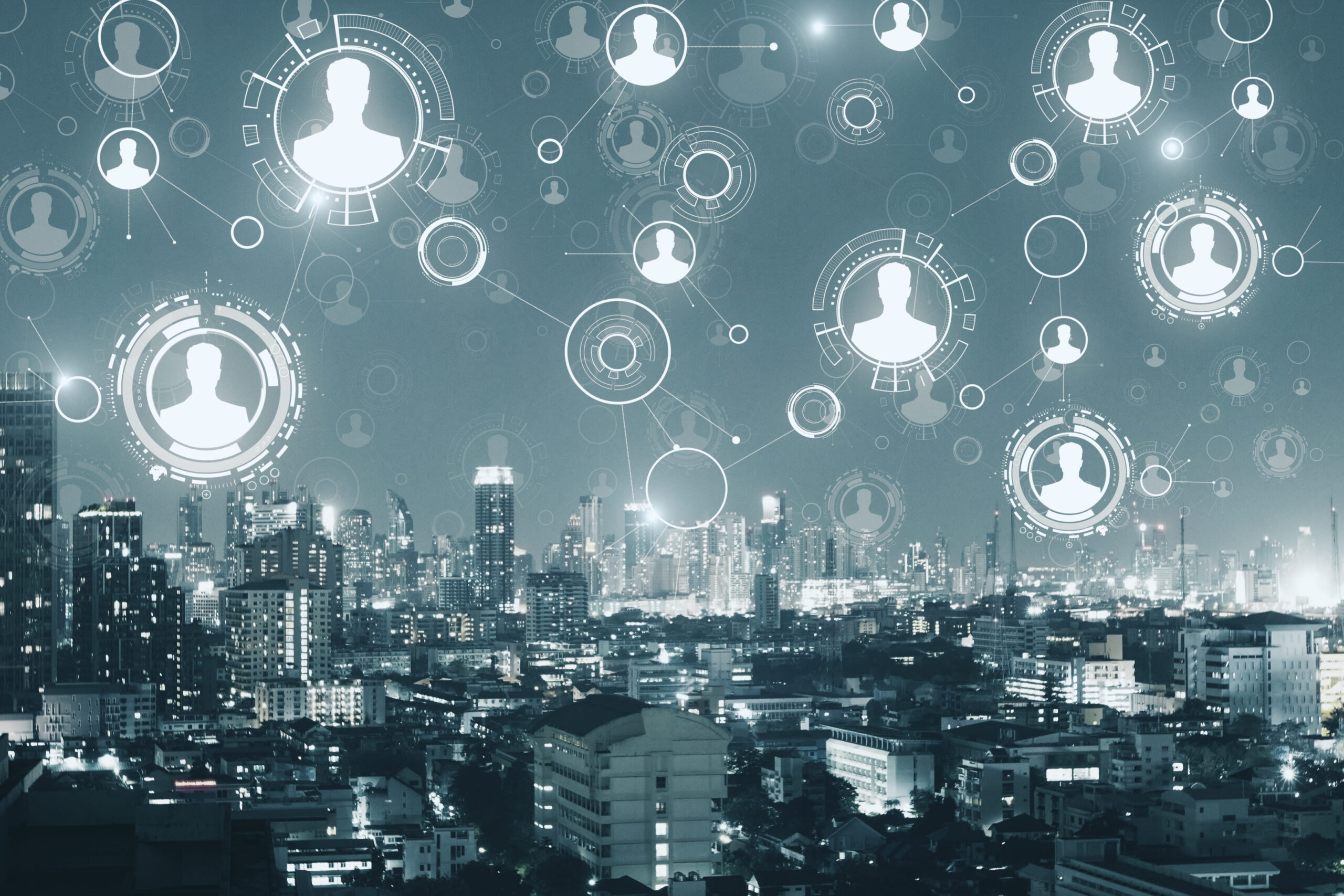 Abstract city skyline at night overlaid with connected digital profile icons and data nodes, representing interconnected HR data, workforce analytics, and the challenge of turning complex people data into actionable insight.