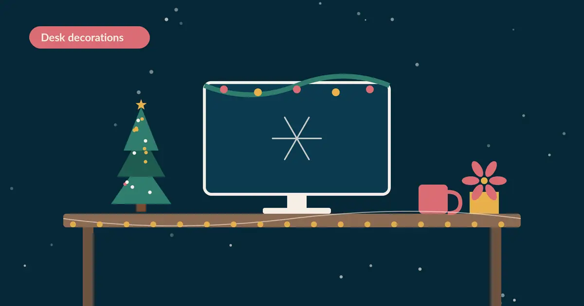 Office desk Christmas decorations with a mini tree, fairy lights, and monitor garland